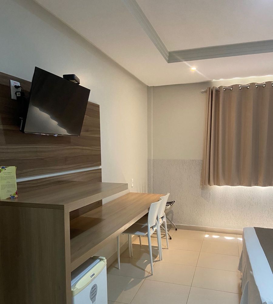 Bancada com TV e frigobar do apartamento Luxo